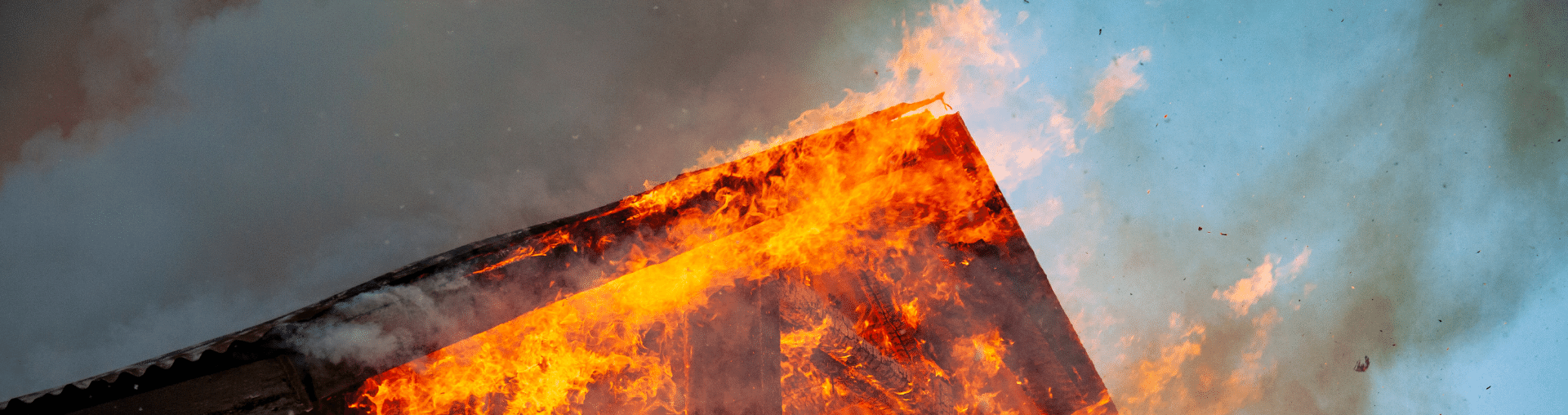 Burning roof illustrating fire-related property damage that may need to be documented for an insurance claim.