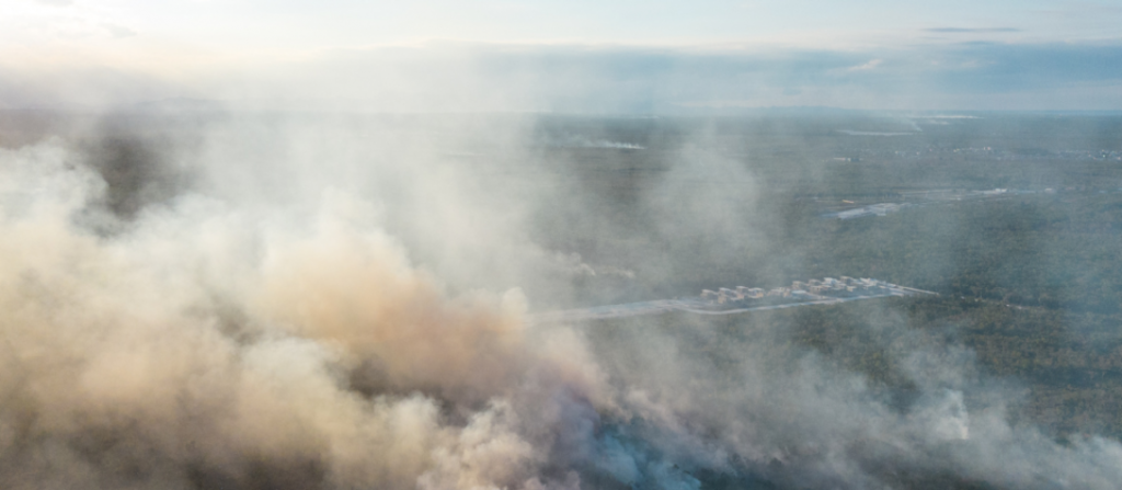 Smoke surrounding a property after a fire, illustrating potential smoke damage to household contents.