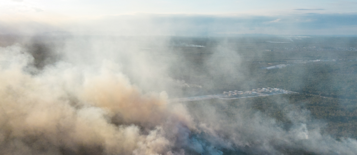 Smoke surrounding a property after a fire, illustrating potential smoke damage to household contents.