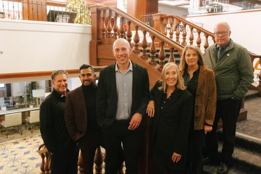 Property Claims Consultant team members standing together indoors.