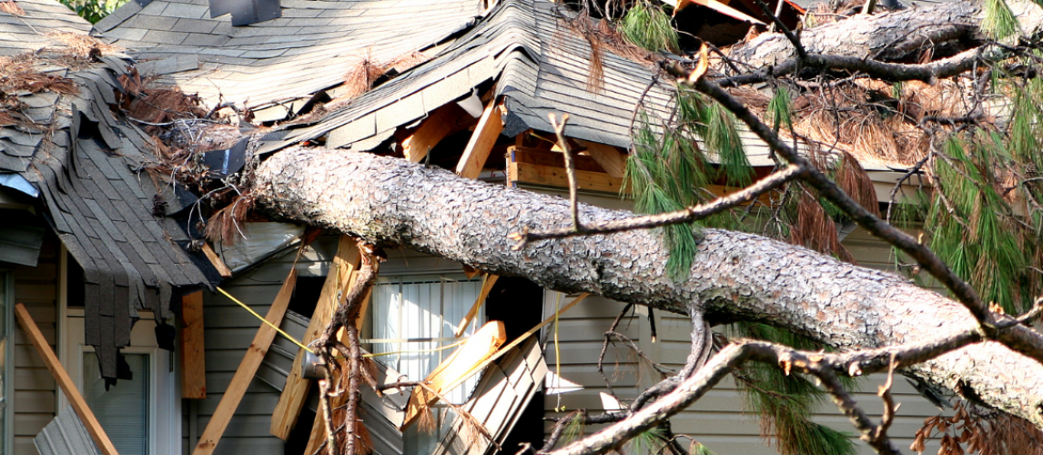 Damaged residential roof shown in a guide to home insurance coverage in California.