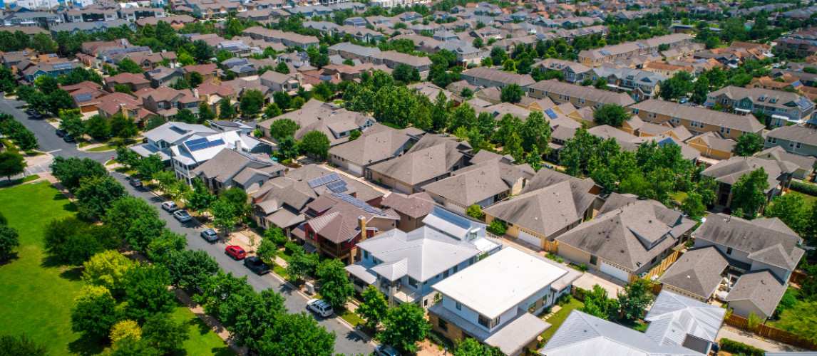 Aerial view of homes in a residential neighborhood accompanying a Property Claims Consultant article.