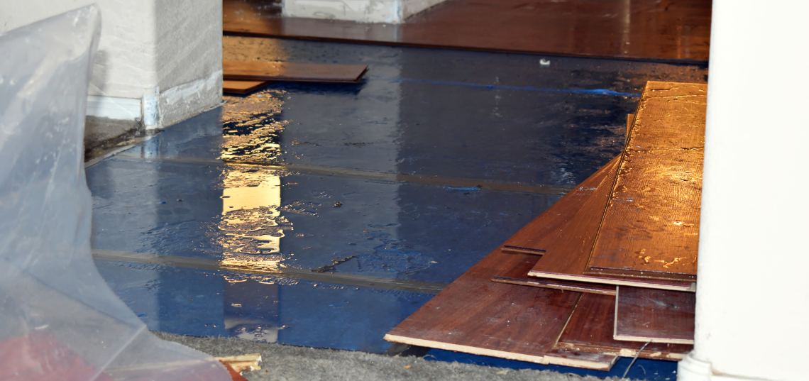 Standing water inside a home after flooding, illustrating water damage documented for a property insurance claim.